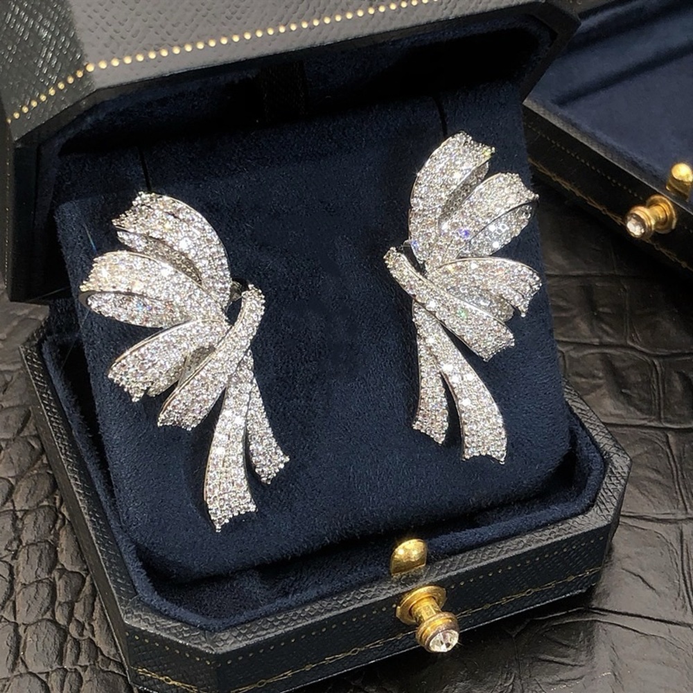 Cubic Zirconia Bow Statement Earrings – Silver Tone ✨